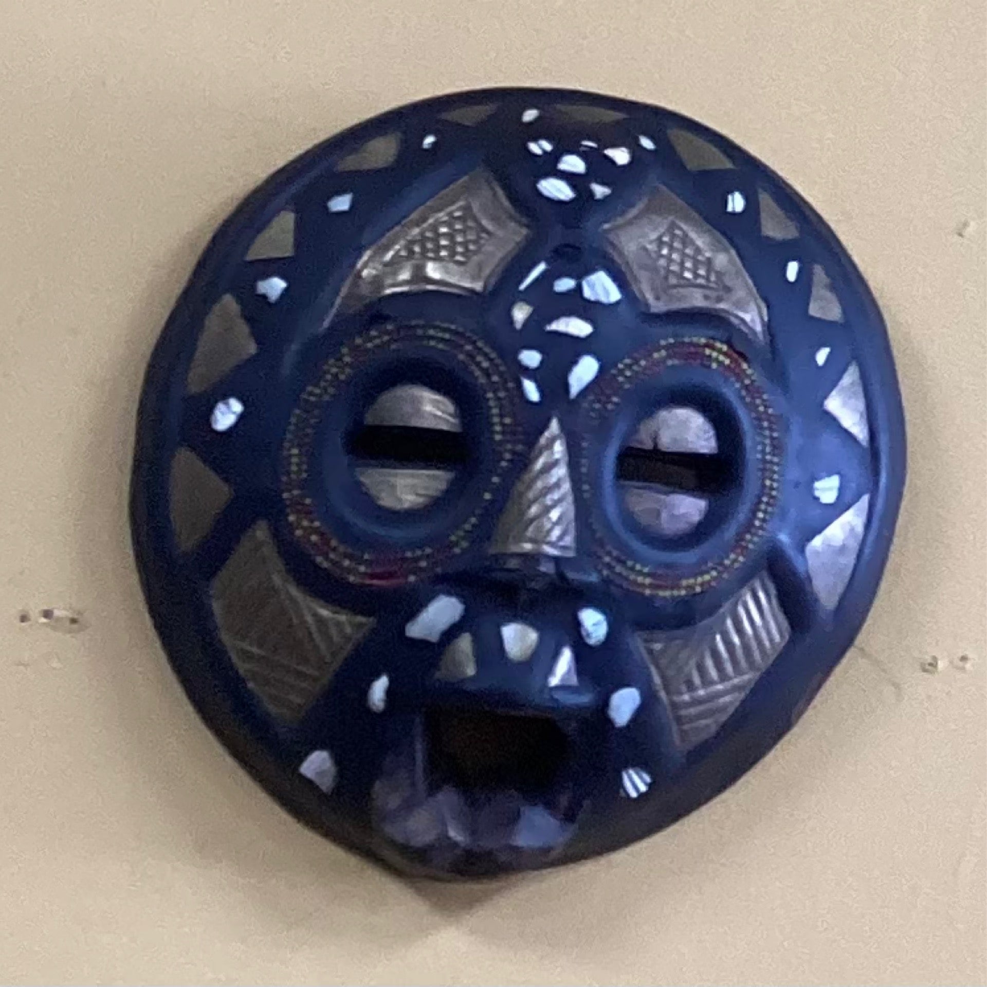 Hand carved circular wall mask (small)